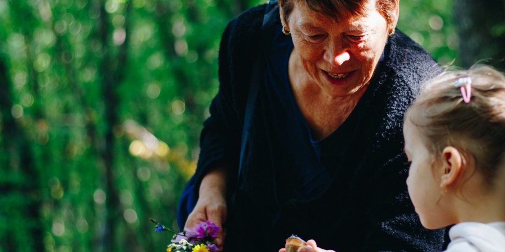 sergiu-valena-7VPdLfzLwg8-unsplash grandmother with grandchild in garden